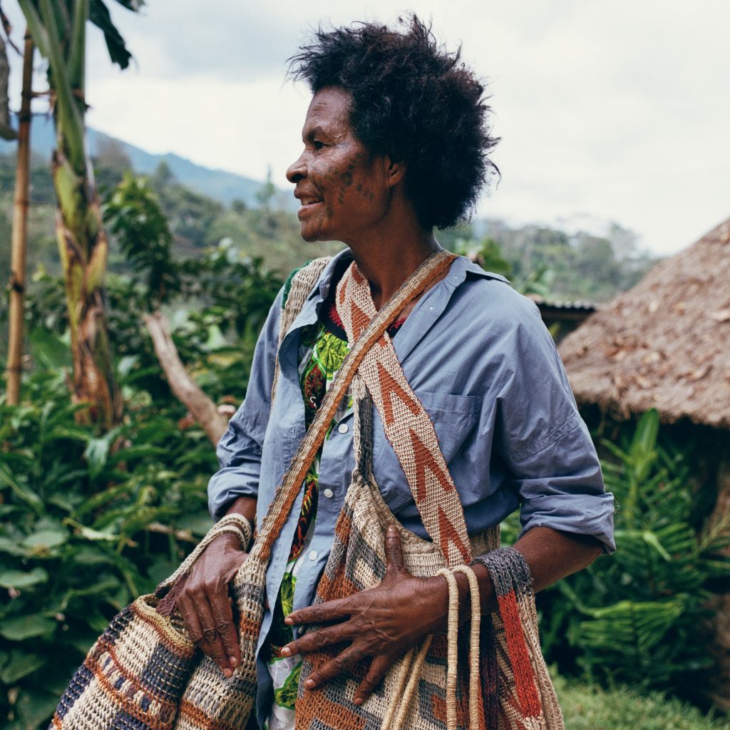 A women from Papua New Guinea holding Bilum bags