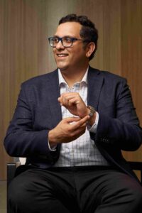 Man adjusting sleeve of suit