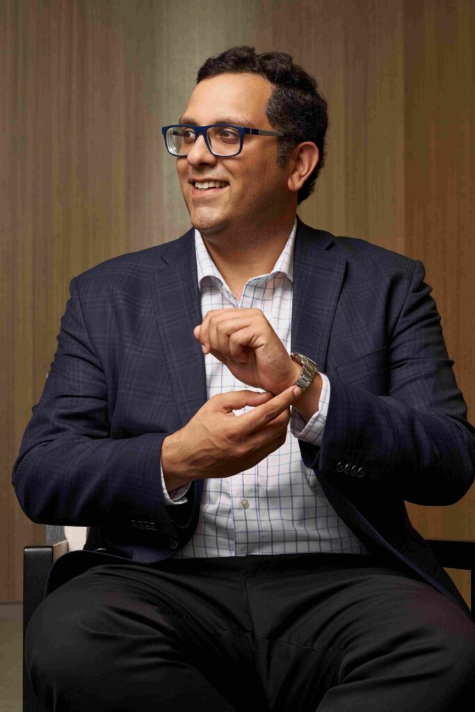 Man adjusting sleeve of suit